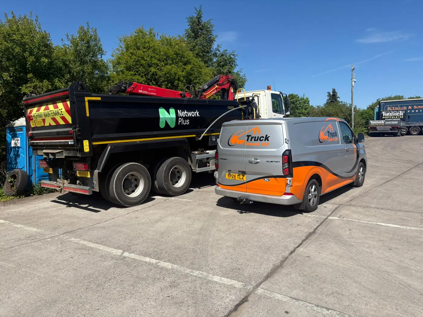 Truck Cranes service vehicle beside a truck-mounted crane